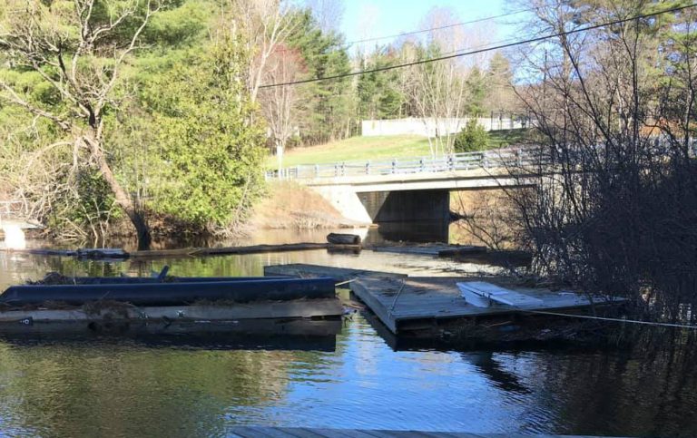 Dock collection piling up on snowmobile bridge