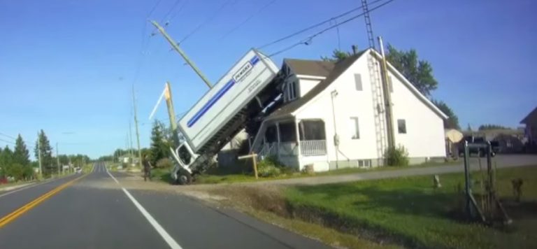 Truck driver charged after truck ends up on Alban house